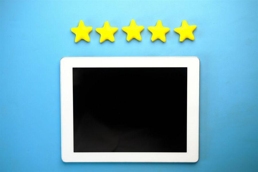 Five gold stars above a tablet