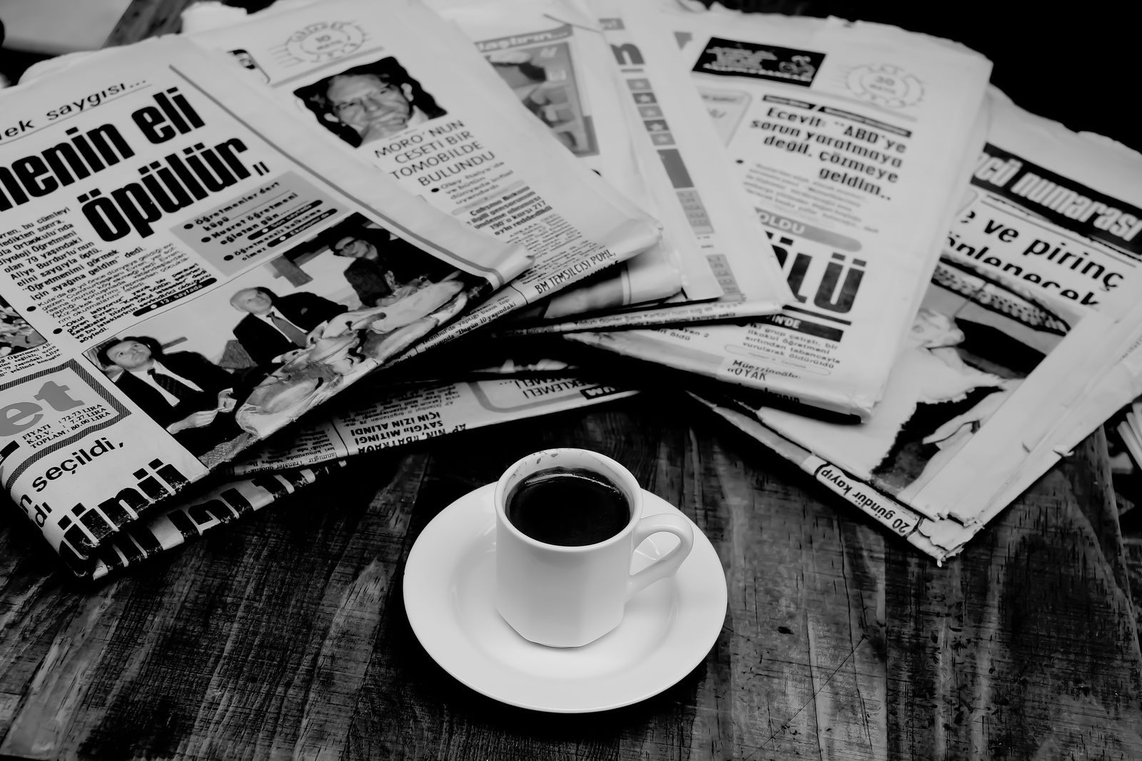 Newspapers and coffee on a table, reading cruise news