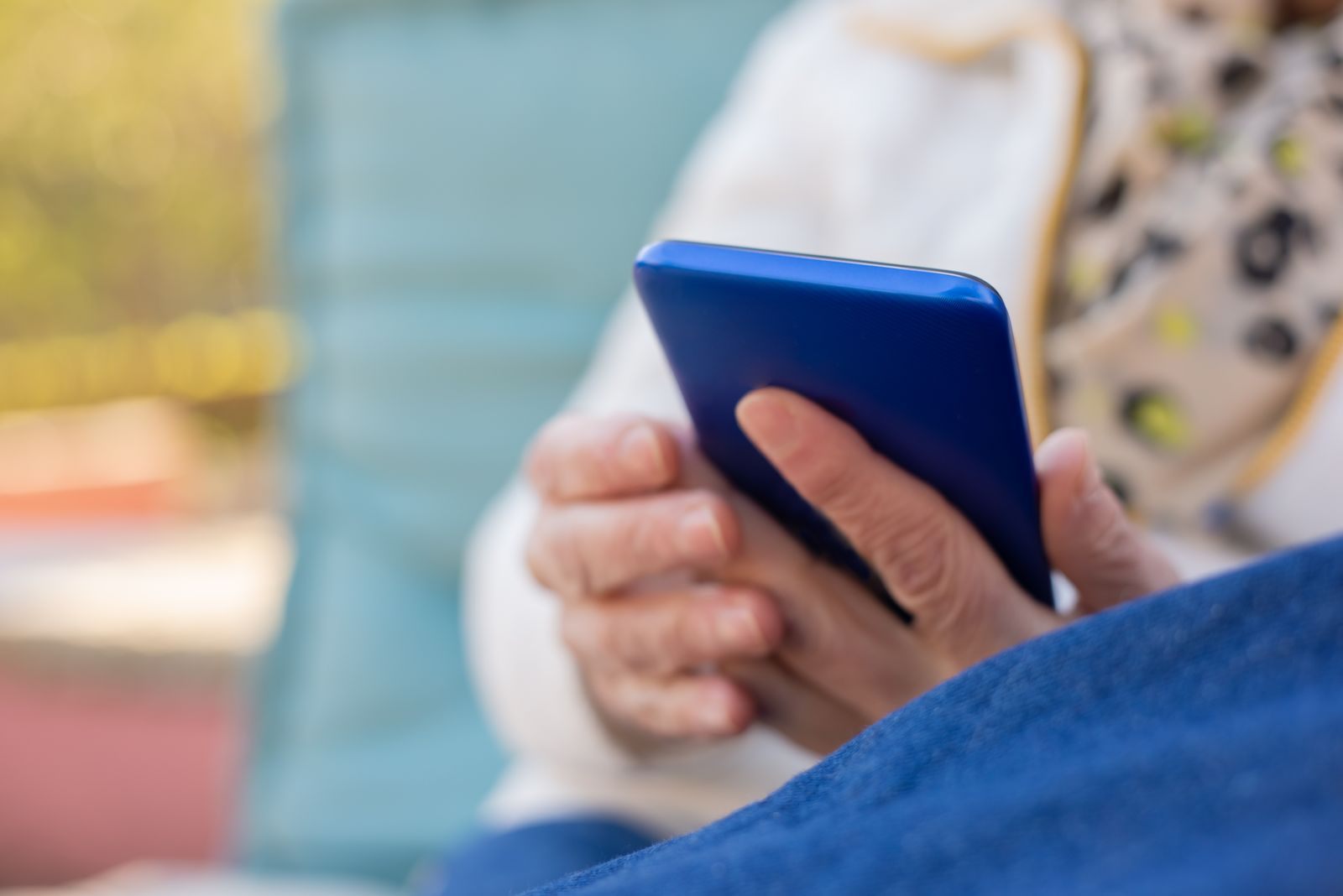 Hands holding a smartphone to read cruise review sites